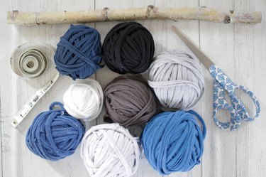 Grab some old t-shirts hanging around in your closet to create an eye-catching and stylish wall hanging.