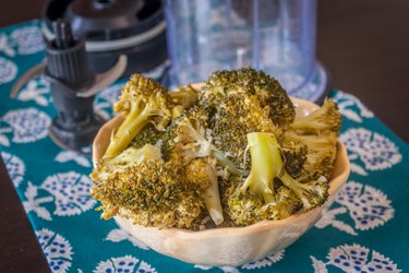 Spoon out broccoli to be pureed.