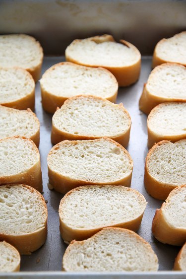 Slice the baguette and place on a baking tray.