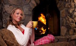 The warm light from a fireplace can help make a room feel cozier.
