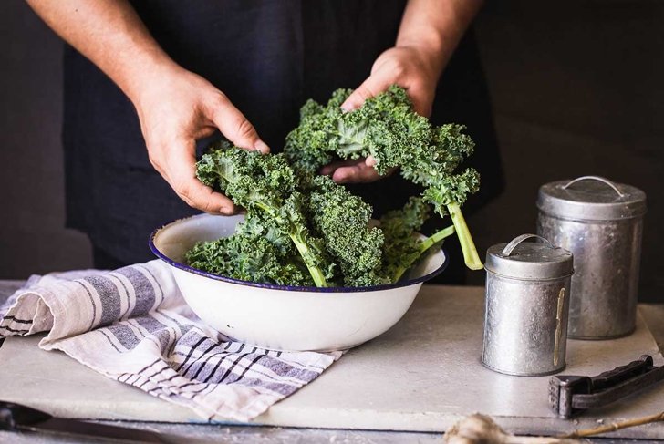 Kale leafy greens vegetable box hold in hands wash black wall raw kale ready to prepare food hand greens leafy