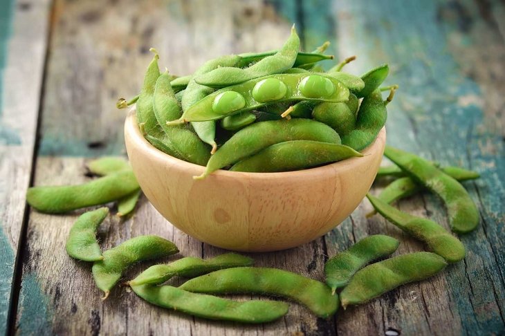 green soy beans in the wood bowl on table