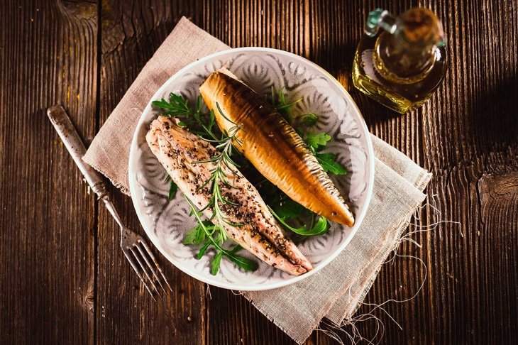 Smoked mackerel on wooden background